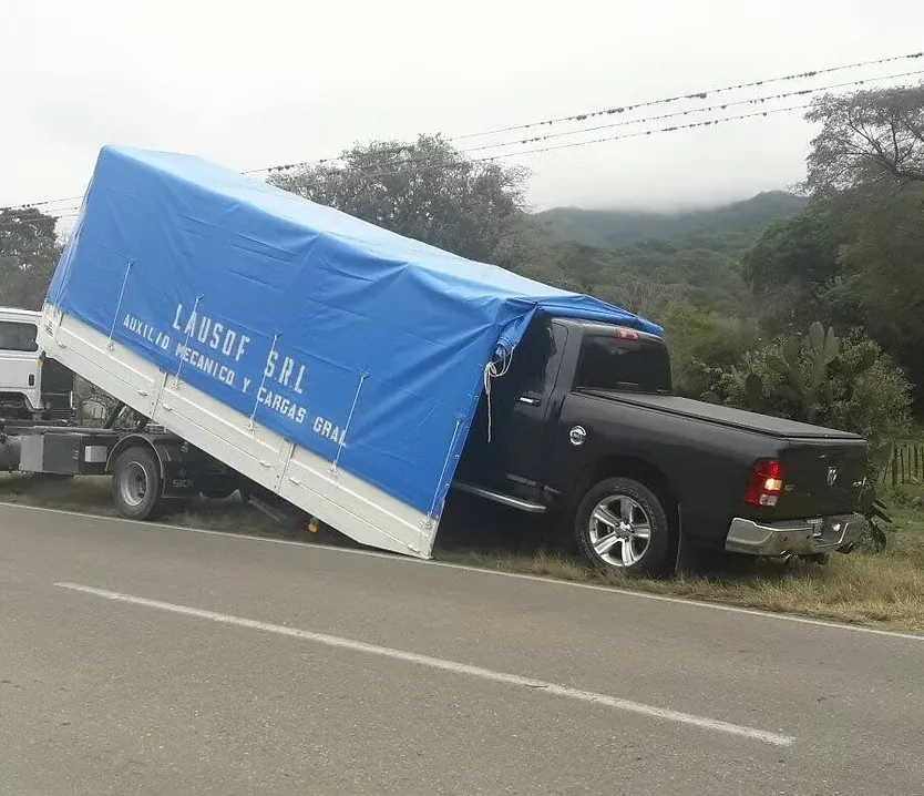 Lausof flatbed tow truck recovering a pickup at the side of the highway